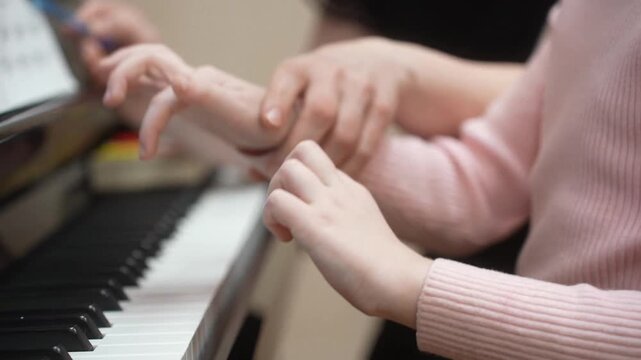 The girl who gives lessons in a piano. Close up. High quality video