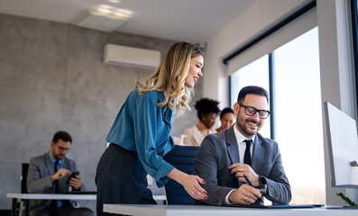 Diverse startup, business people working together on laptop computer in modern office