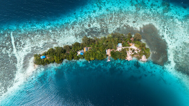 Aerial view of a lush, tropical island surrounded by turquoise and deep blue waters, a tranquil haven in the vast ocean, Solomon Islands, Solomon Islands, Solomon Islands.
