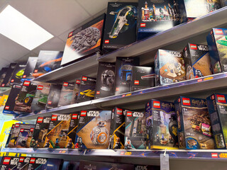 Naklejka premium Shelves of boxed lego sets in retail store