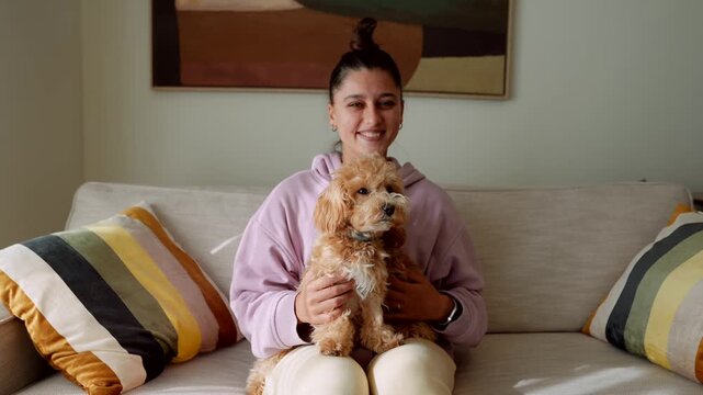 Brightly lit living room scene with woman and puppy together
