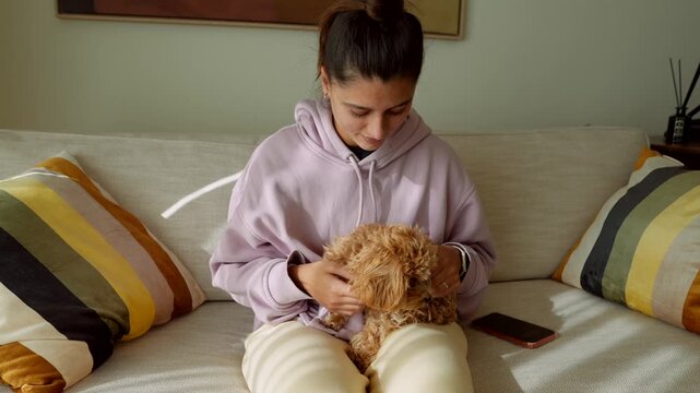 Relaxed student shares happy moment with lively puppy at home