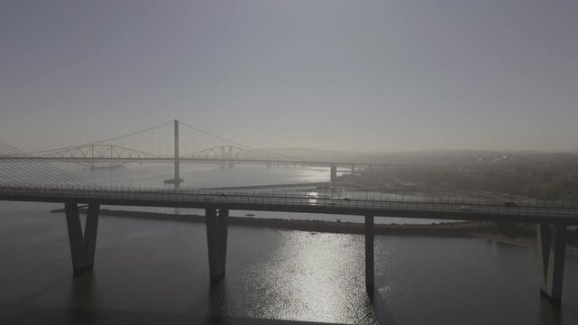 Aerial view of the stunning Queensferry Crossing and Forth Road Bridge over the water, connecting the coast, South Queensferry, United Kingdom.