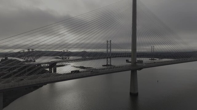 Aerial view of bridges over water, the Forth Bridge and Queensferry Crossing stand as marvels of engineering, South Queensferry, United Kingdom.