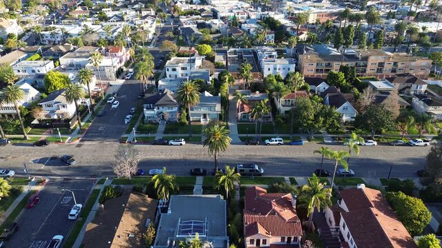 Residential blocks north of E Ocean Blvd and Coronado Ave show orderly Bluff Park grid with repeating STOP controls and dense housing patterns. Varied shingles, trimmed foliage, Long Beach, CA