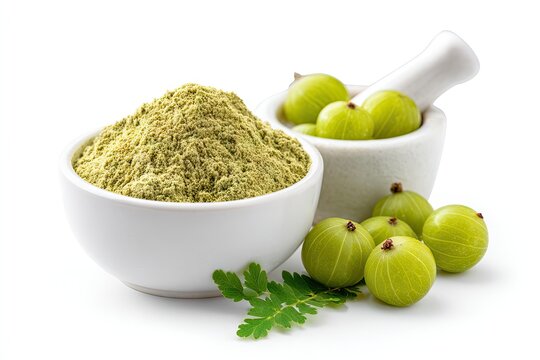 Green powder, fruits, and mortar & pestle against white