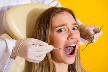 Dental checkup and teeth whitening scene as smiling young woman receives care in a bright clinic
