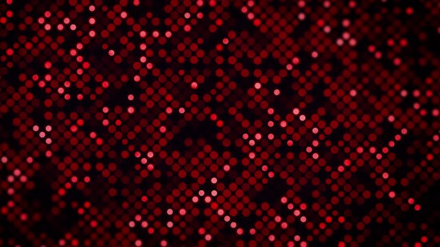 Dark background featuring a dense grid of red circles with varying brightness and a subtle blur effect. Red and black circular dot pattern abstract loop animation.