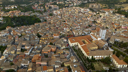 Aerial view of Melfi, a town in Basilicata, Italy. Historic Italian village with clustered stone houses and terracotta roofs. The dense urban layout showcases traditional Mediterranean architecture.
