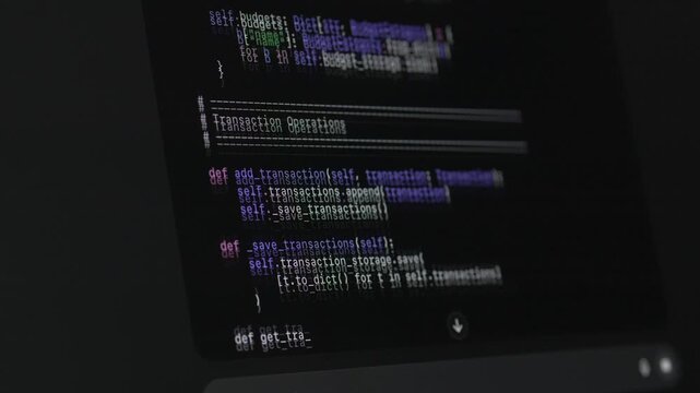Source code displayed on monitor during vibe coding with ai assistant on dark interface. Multicolored syntax highlights programming structure, automation workflow and modern artificial intelligence 