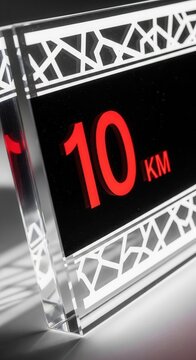 Illuminated 10km Distance Marker With Geometric Design and Reflective Surface