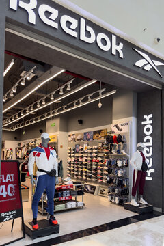 Thiruvananthapuram, India - December 24, 2025: Reebok store entrance showcasing athletic apparel and footwear with mannequins and promotional signage visible inside