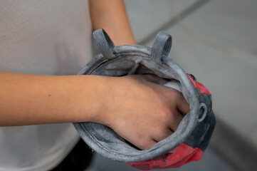 Close Up of Climber Hands Using White Chalk Powder in a Red Chalk Bag for Better Grip at Gym