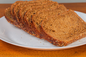 Slices of cereal brown bread on a plate close-up