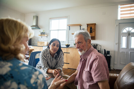 Care coordinator meeting with senior couple at home