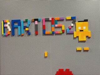 Naklejka premium Colorful lego lettering and pixel character