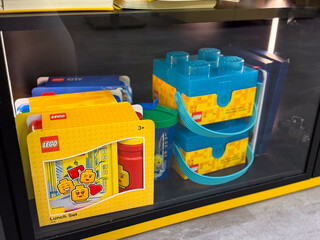Naklejka premium Lego lunch set and blue brick containers on display