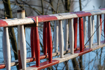 Red and white wooden railing indicating barrier or boundary