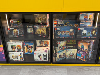 Naklejka premium Lego brickheadz sets displayed in glass retail cabinet