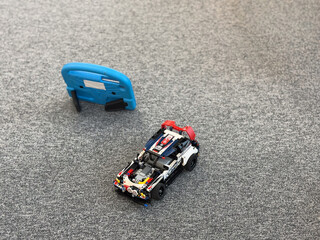 Naklejka premium Lego-style race car on carpet