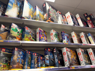 Naklejka premium Shelves of boxed lego sets in retail
