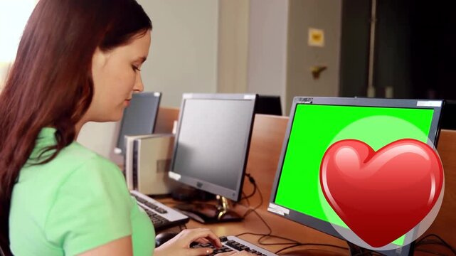 Red heart icon against caucasian using computer with copy space at school