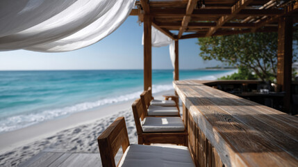 Obraz premium A serene beachside bar with wooden seating and serene ocean views, defined by soft fabrics and natural elements, perfect for a tranquil retreat to enjoy the beauty of nature.