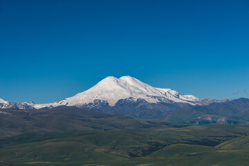 Snow-Capped Mount Elbrus Peak Against Clear Blue Sky
