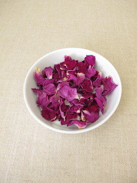 Dried rose petals from the beach rose in a porcelain dish, Rosa rugosa
