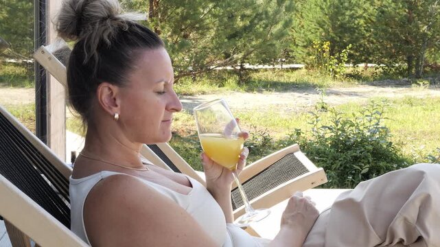 Healthy morning routine ritual woman enjoying calm rest with fresh fruity drink on terrace Balanced lifestyle moment mindful relaxation Support through drink choice daily wellness powered by drink