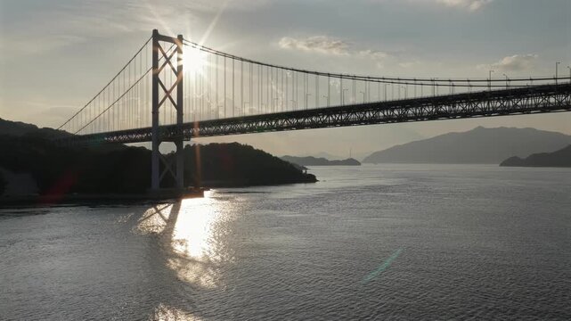 Drone flying under Innoshima Bridge at sunset, Seto Inland Sea Japan, award-winning cinematography