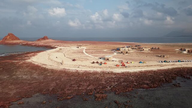 Aerial view of remote desert island campsite by the sea