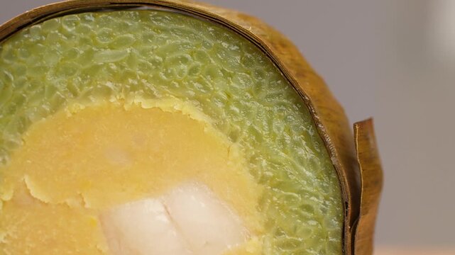 Macro panning shot of savory Banh Tet sticky rice cake cross section