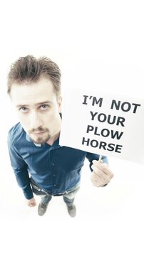 Man holding sign I'm Not Your Plow Horse top down view on white background