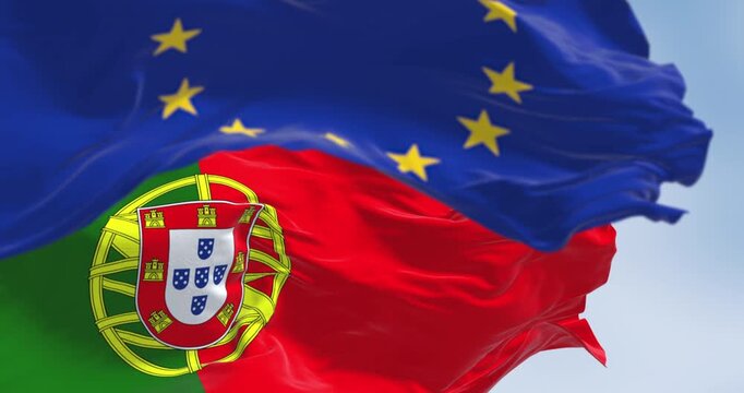 Close-up of Portugal and the European Union flags waving on a clear day
