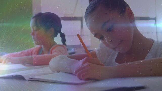 Animation of light spots over diverse schoolgirls writing