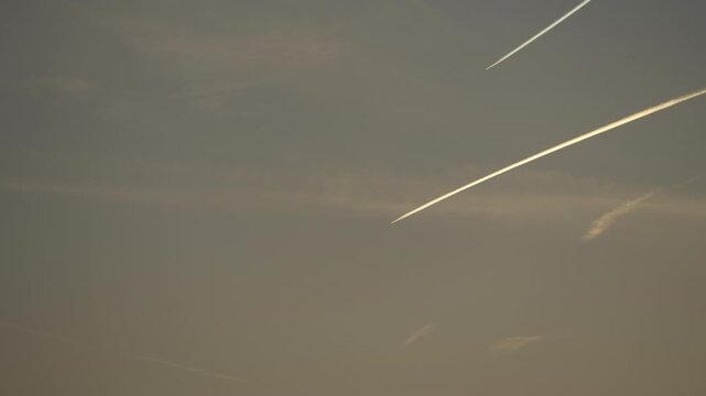Two high‑altitude aircraft producing parallel contrails in the upper atmosphere