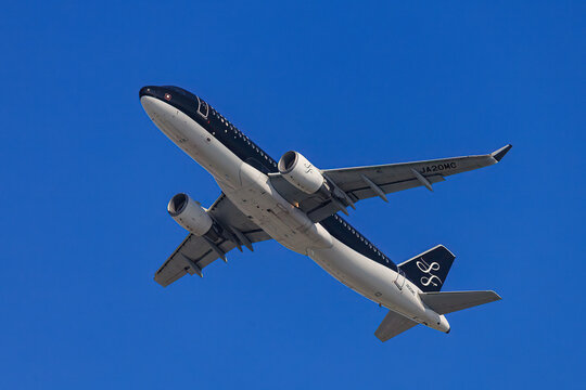 Fukuoka Japan - 2021 June 19: A StarFlyer Airbus A320 aircraft (JA20MC) takes off and climbs from Fukuoka Airport against a clear blue sky.
