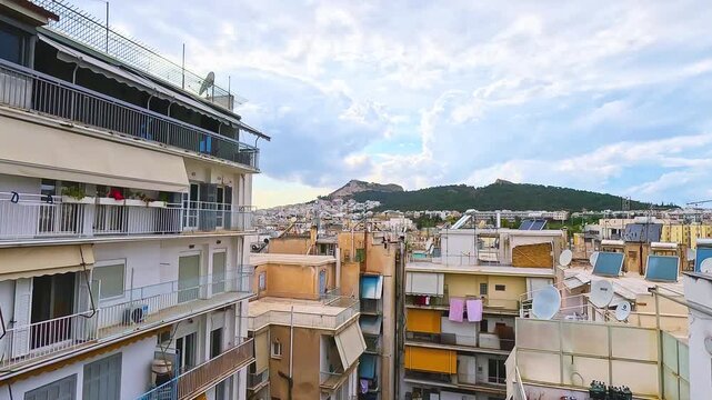 Athens Greece Ilisia residential district walking out to home house apartment balcony with cityscape view on mount Lycabettus Lykavitos hill park