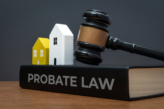 Miniature houses, judge's gavel and a PROBATE LAW book. Inheritance, estate planning, property law, and legal asset distribution concept.