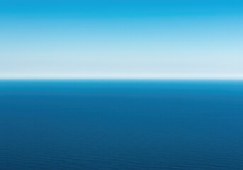 Fototapeta premium A breathtaking view of the endless ocean stretching toward the sky. The clean horizon line divides the deep blue water and atmospheric air ,escape ,sunny ,background