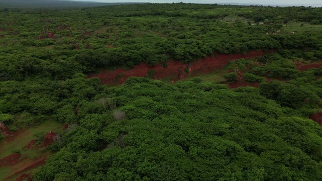 Aerial footage of striking red mineral landforms creating dramatic natural scenery.