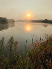 Fog over the river at dawn, autumn landscape.