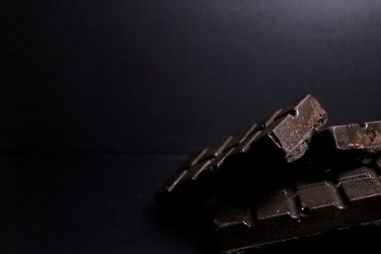 chocolate bar on black background with negative space
