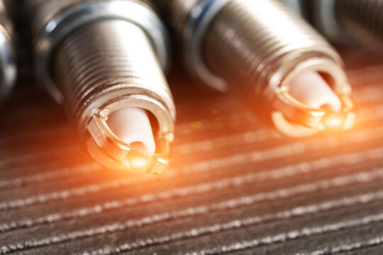 Automotive spark plugs with glowing electrode tips ignition system component for engine power generation and vehicle performance.