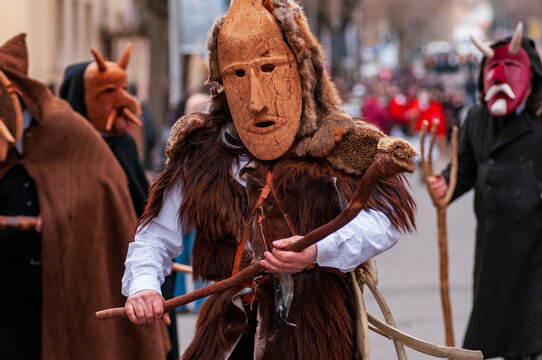 Traditional "Su Bundu" mask performer during carnival parade in Orani, Sardinia, wearing wooden mask and fur costume, representing ancient folkloric ritual and cultural heritage in Italy