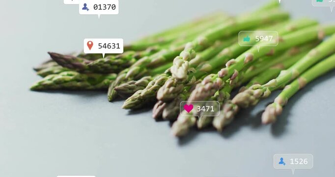 Chat bubble and bell icon fading above asparagus, icons clustering and floating showing engagement