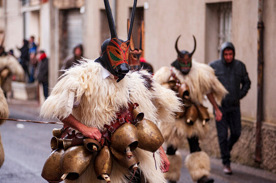 Traditional Boes masks from Ottana during Sardinian carnival parade, featuring horned wooden masks, sheepskin costumes and bells, representing ancient pastoral folklore traditions in Sardinia, Italy