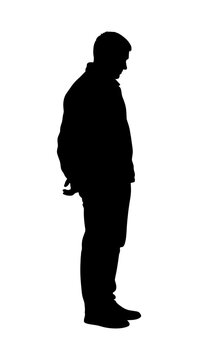 Full-length black silhouette of a man standing in profile, with his head bowed and hands clasped behind his back, isolated on a white background.