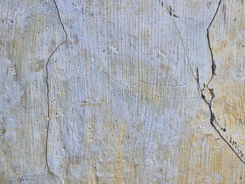 Blue and beige weathered plaster wall texture with peeling paint abstract vintage background surface
